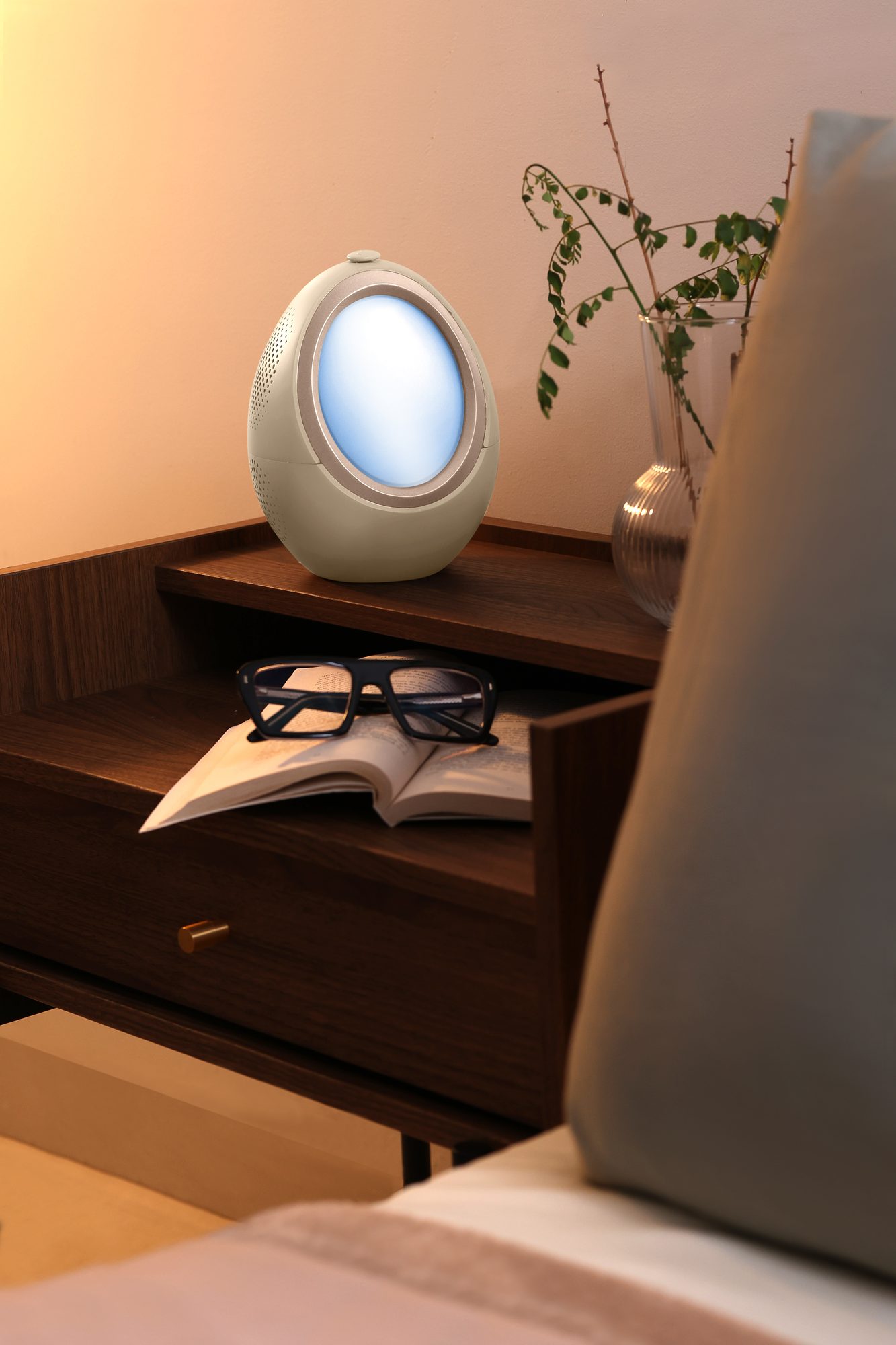 The Naptick device glowing warmly on a bedside table